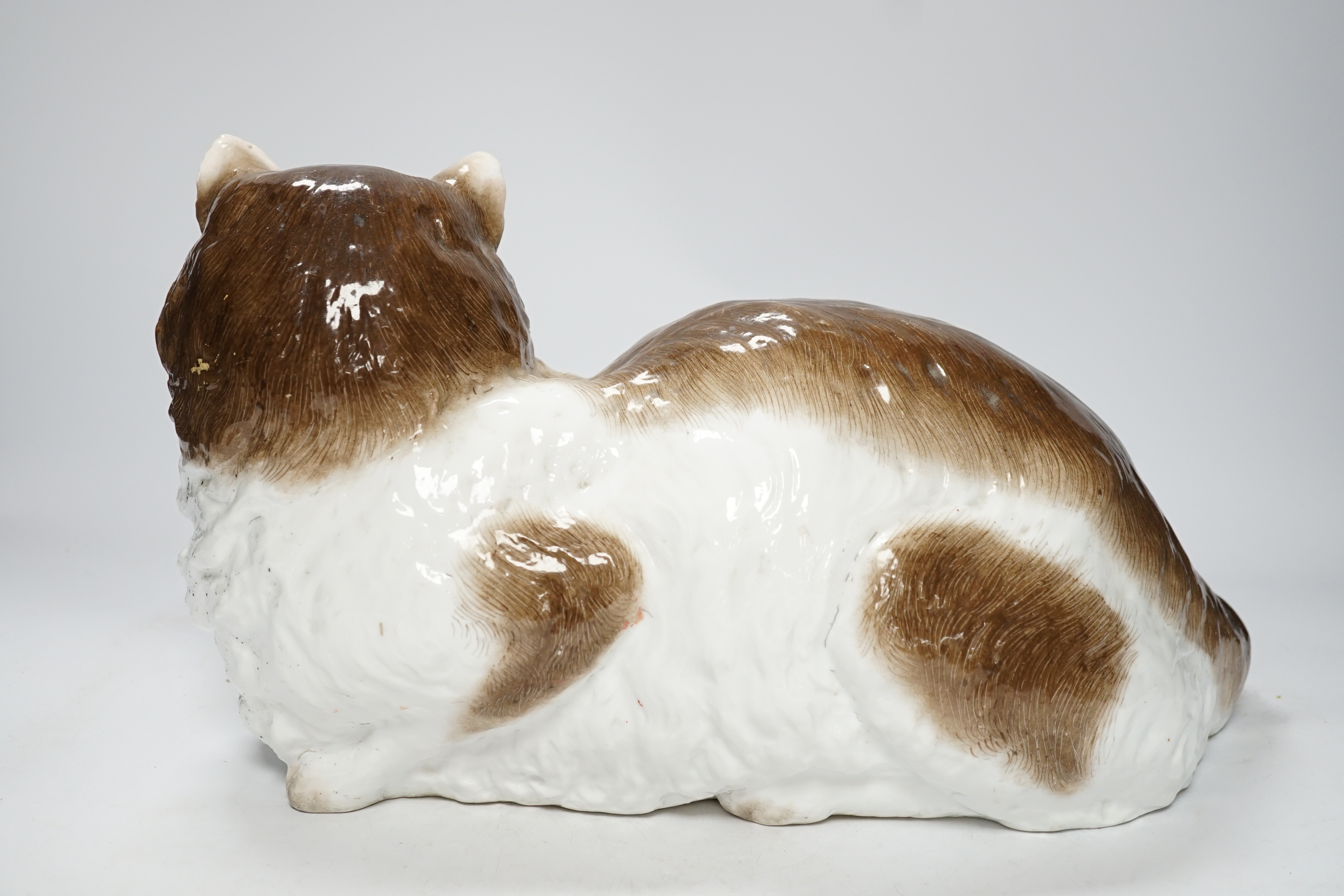 A large Meissen style figure of a seated cat, pseudo crossed swords mark to the base, 37cm wide